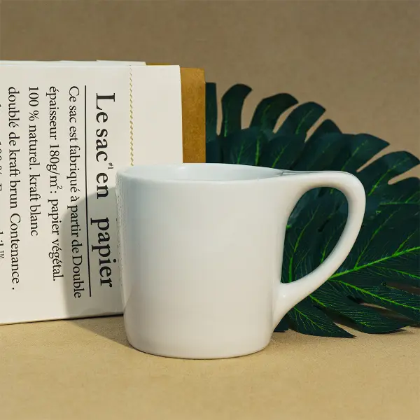 Tasse à café en céramique à bouche plate avec bord lisse et design blanc minimaliste