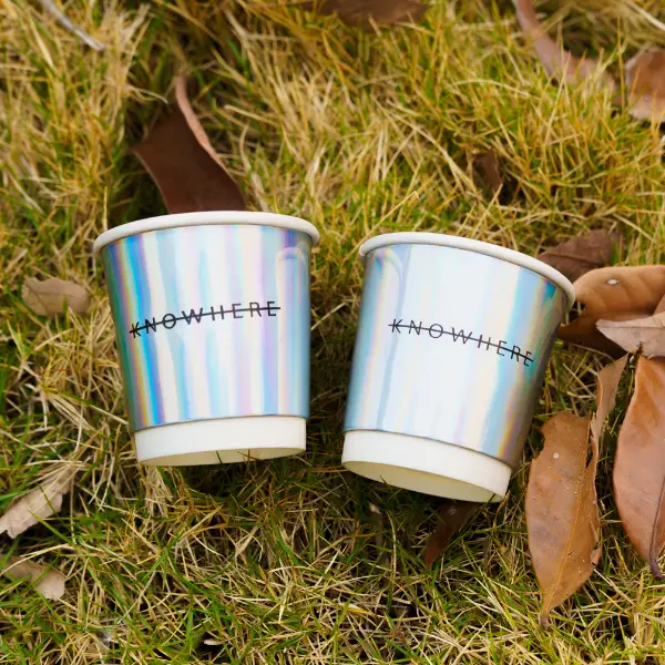 Tasses en papier holographiques avec feuille d’aluminium arc-en-ciel dans la scène de la vie en plein air