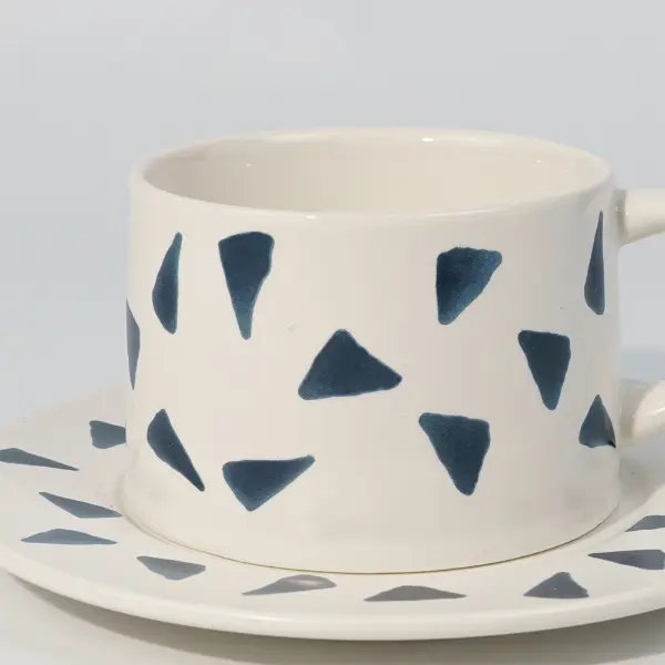 Vue latérale d’une tasse à café en céramique imprimée montrant la poignée et le motif imprimé